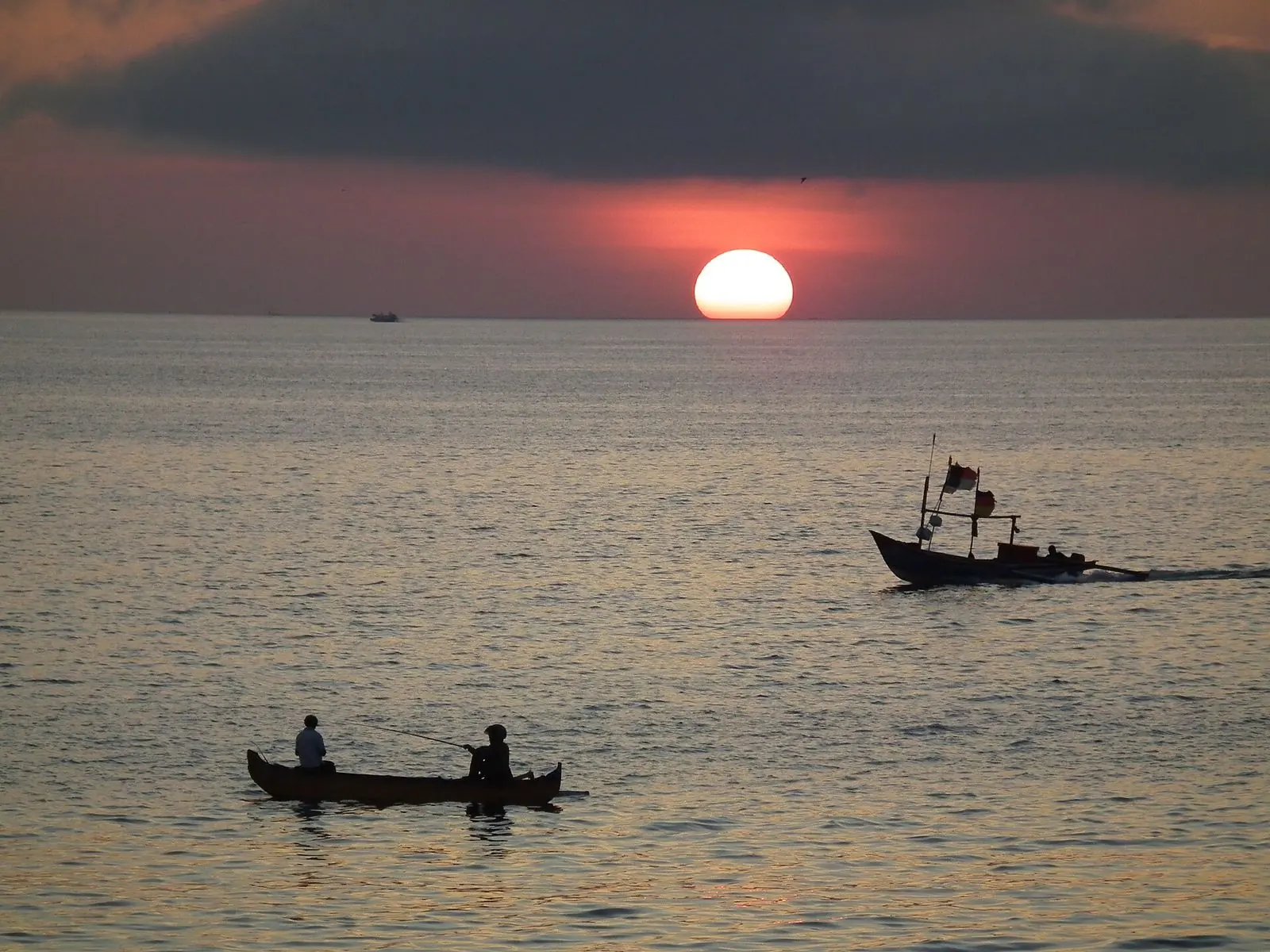 Sunset over Jimbaran Bay with fishing boats